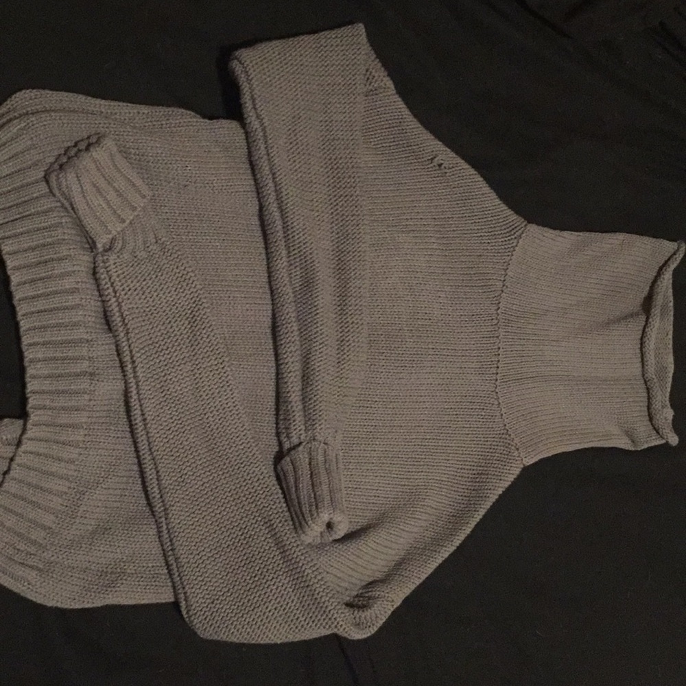 A grey long sleeve turtleneck sweater.